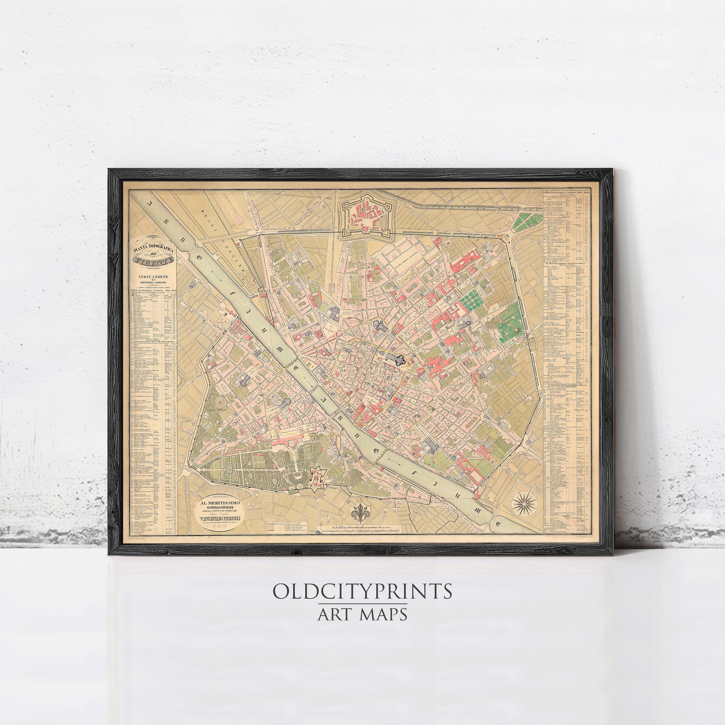 The image is a framed vintage map of a city, likely from the 19th century, displayed on a wall.