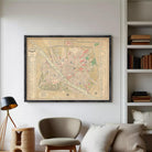 The image is a framed vintage map of a city, likely from the 19th century, displayed on a white wall.
