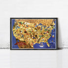 The image is a framed poster depicting a colorful and detailed map of the United States, with various landmarks, symbols, and people represented across the different regions.