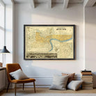 The image is a framed vintage map of London, England, with a black border and yellow and blue color scheme.