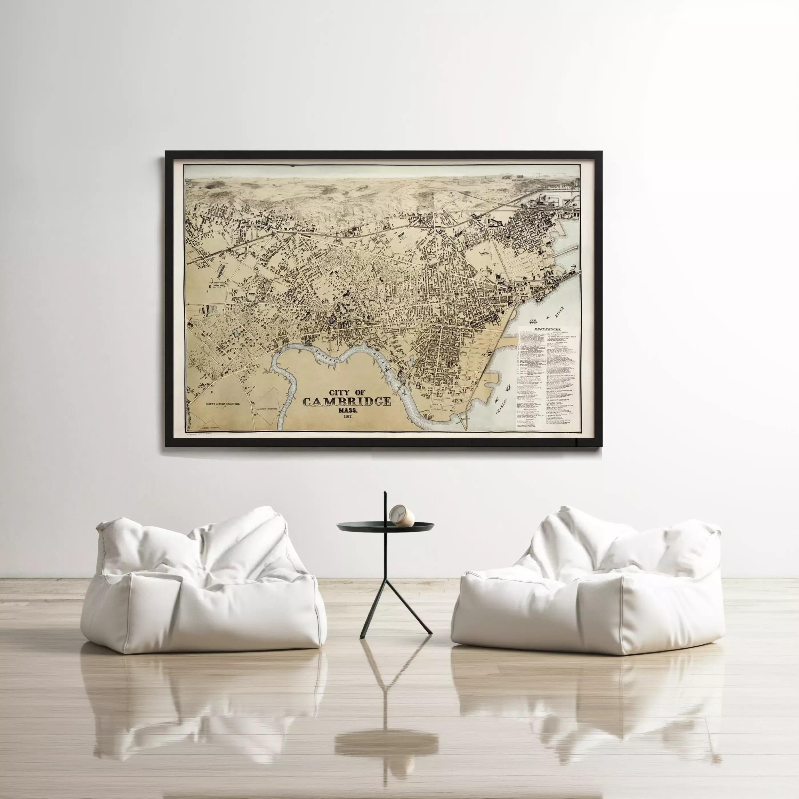 a large framed map of Cambridge, with two white bean bag chairs positioned in front of it, creating a cozy and inviting atmosphere.