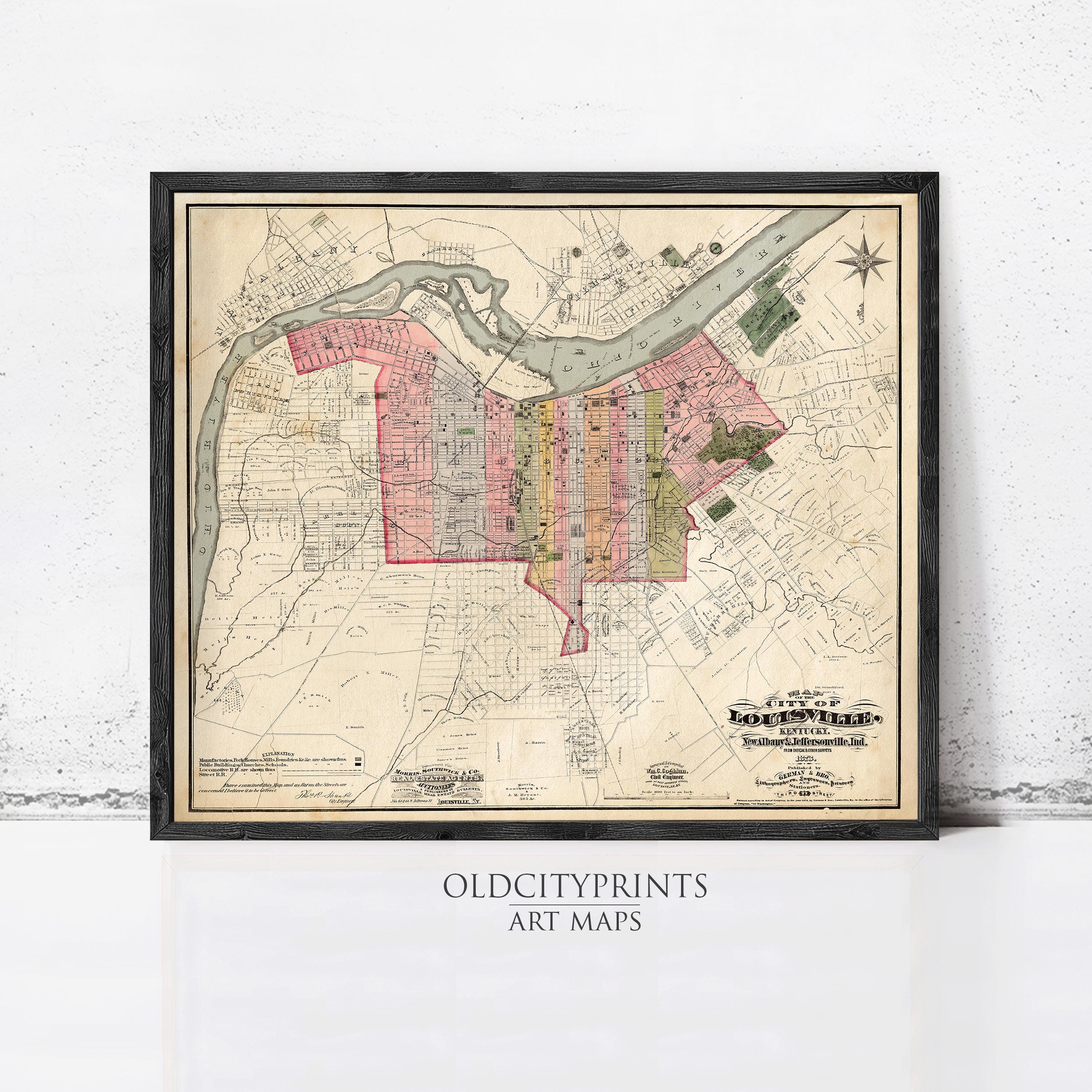 The image is a framed vintage map of a city, depicting the layout of streets, neighborhoods, and other geographical features.