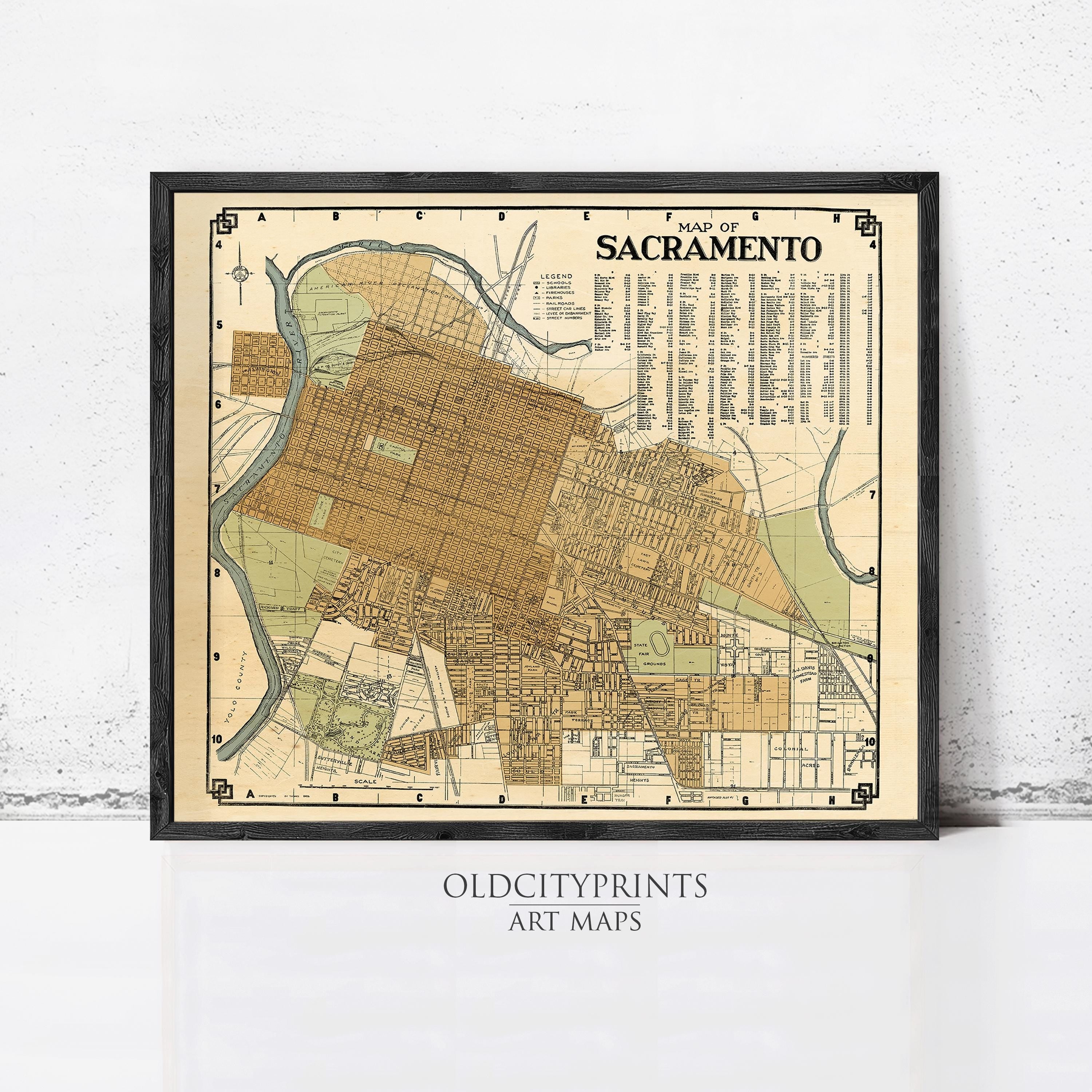 The image is a framed vintage map of Sacramento, California, depicting the city's layout and surrounding areas.