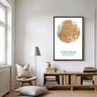 a cozy living room with a large framed map of Memphis hanging on the wall. The room has a wooden bookshelf filled with books, a comfortable chair, and a lamp providing soft lighting.