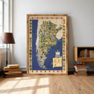 a large framed map of Argentina, with various landmarks and locations marked on it. The map is displayed on a wall in a room with a bookshelf and a lamp.