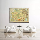 a large framed map hanging on a white wall, with two white bean bag chairs positioned in front of it.