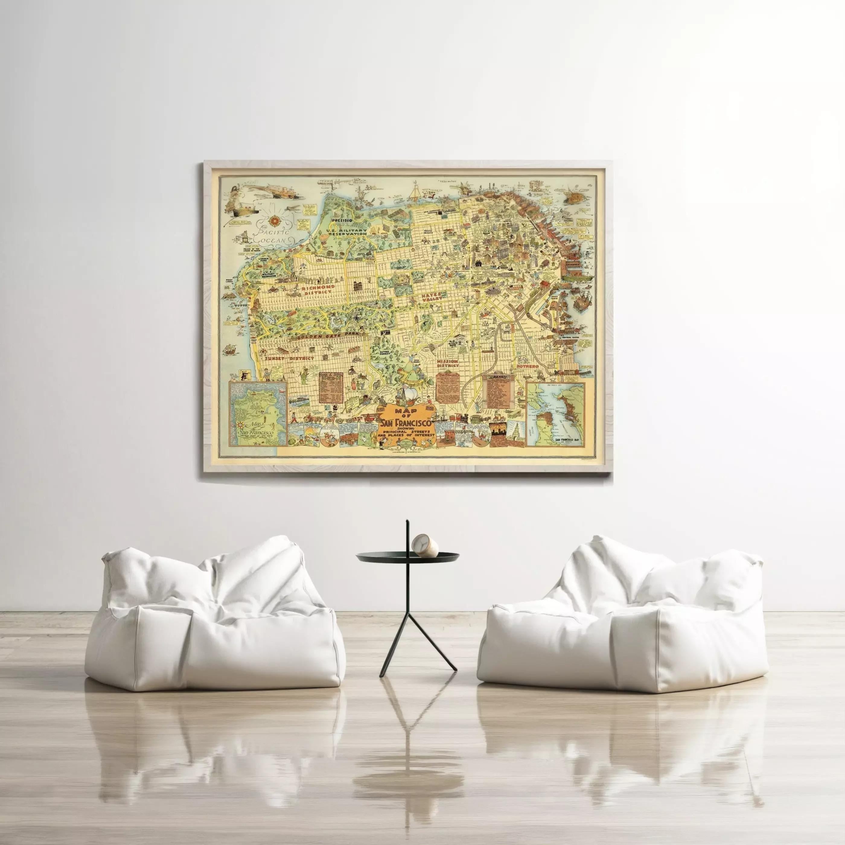 a large framed map hanging on a white wall, with two white bean bag chairs positioned in front of it.