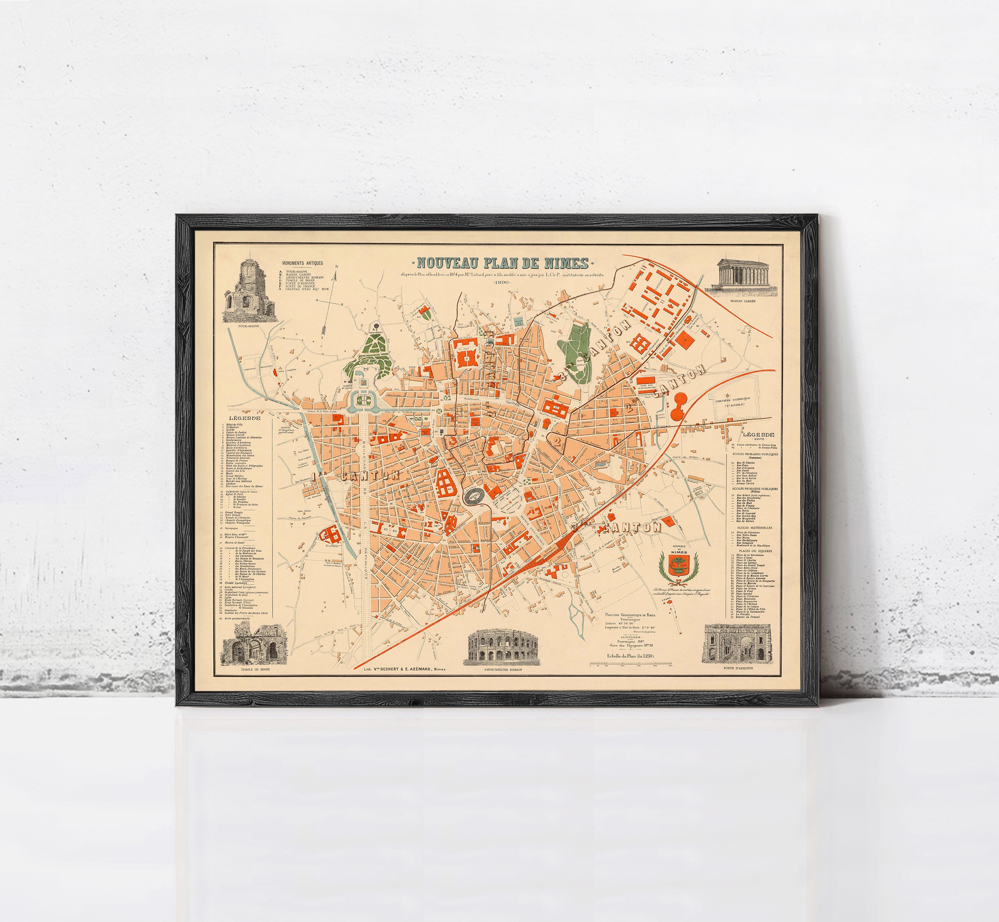 The image is a framed vintage map of a city, depicting various landmarks and streets.