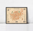 The image is a framed vintage map of a city, depicting various landmarks and streets.