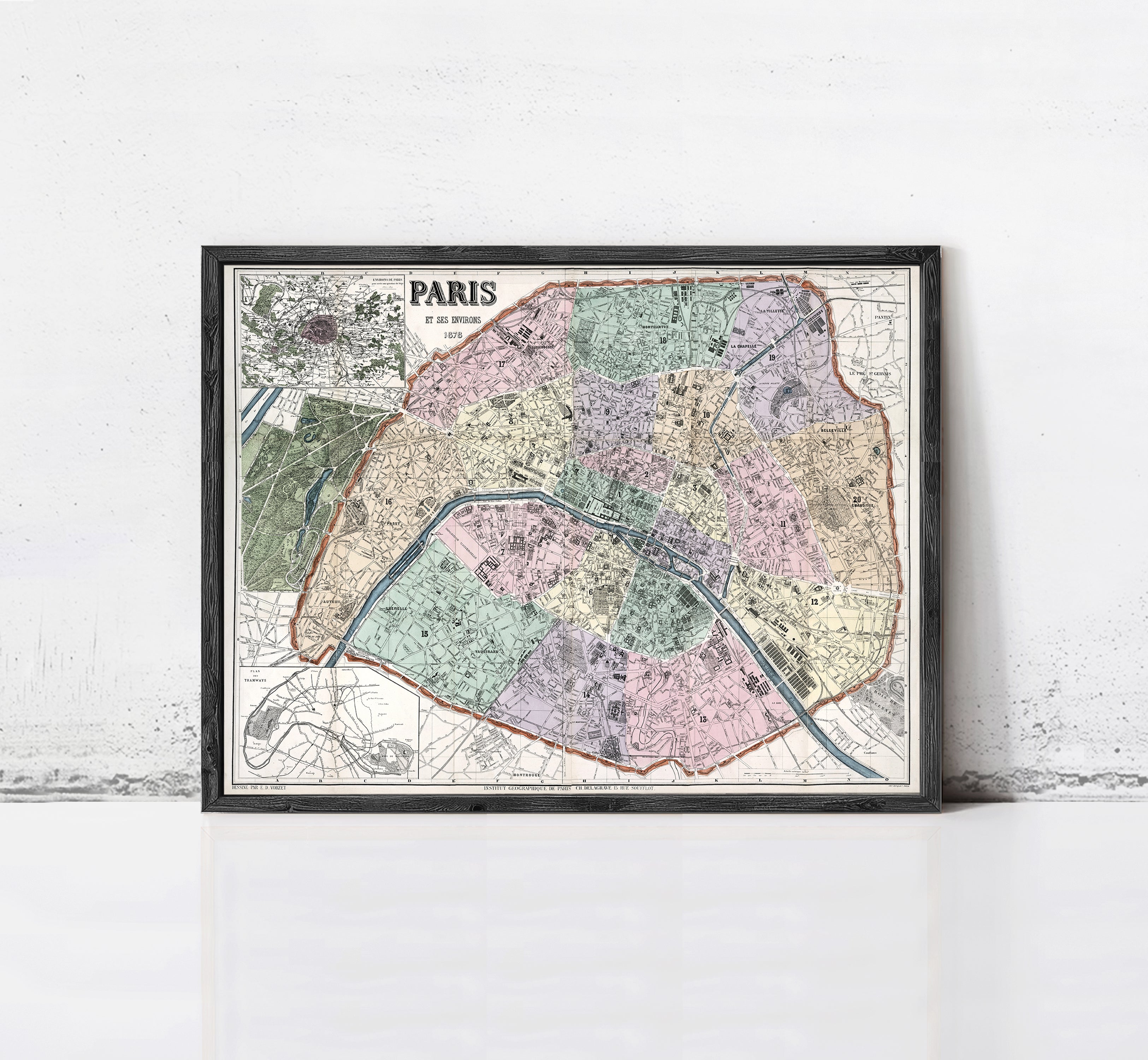 The image is a framed vintage map of Paris, France, depicting the city's streets and neighborhoods in a detailed and colorful manner.