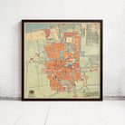 The image is a framed map of a city, likely from the 19th century, depicting a detailed layout of the city's streets, buildings, and other landmarks.