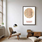 a living room with a chair, a lamp, and a bookshelf. There is a framed map of Chicago hanging on the wall, and a potted plant is located next to the chair.