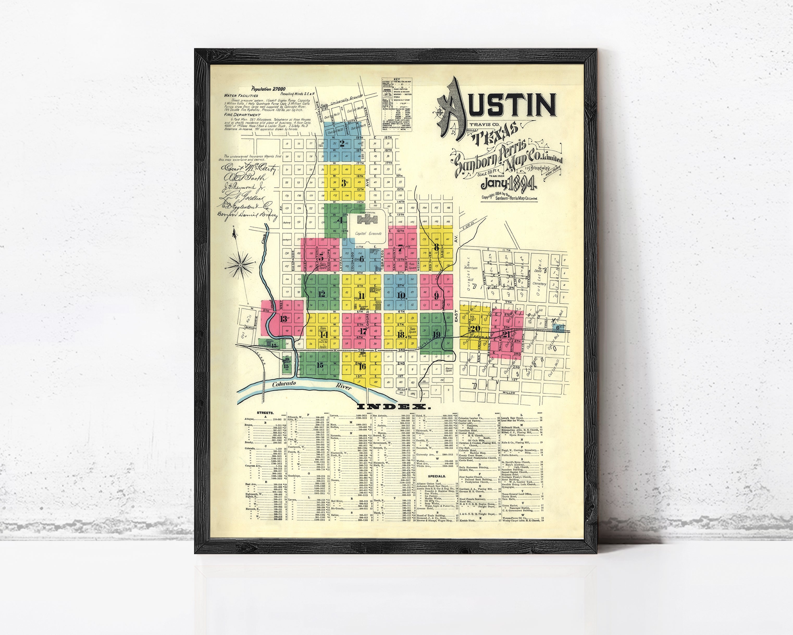 The image is a framed vintage map of Austin, Texas, depicting the city's layout and surrounding areas.