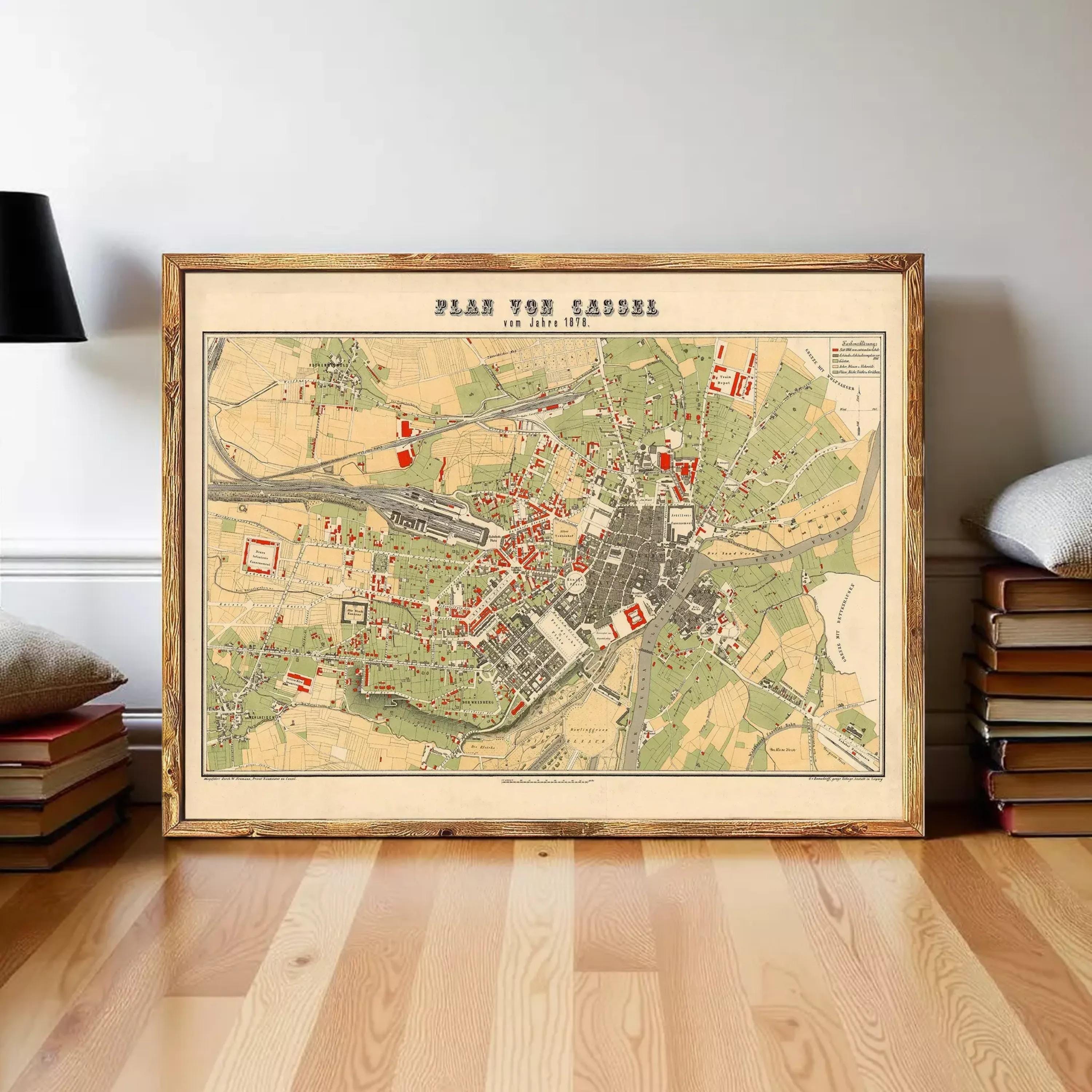 The image is a framed vintage map of a city, likely from the 19th century, depicting various landmarks and streets.
