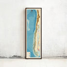 a tall, narrow framed map of South America, specifically Chile, standing against a white wall.