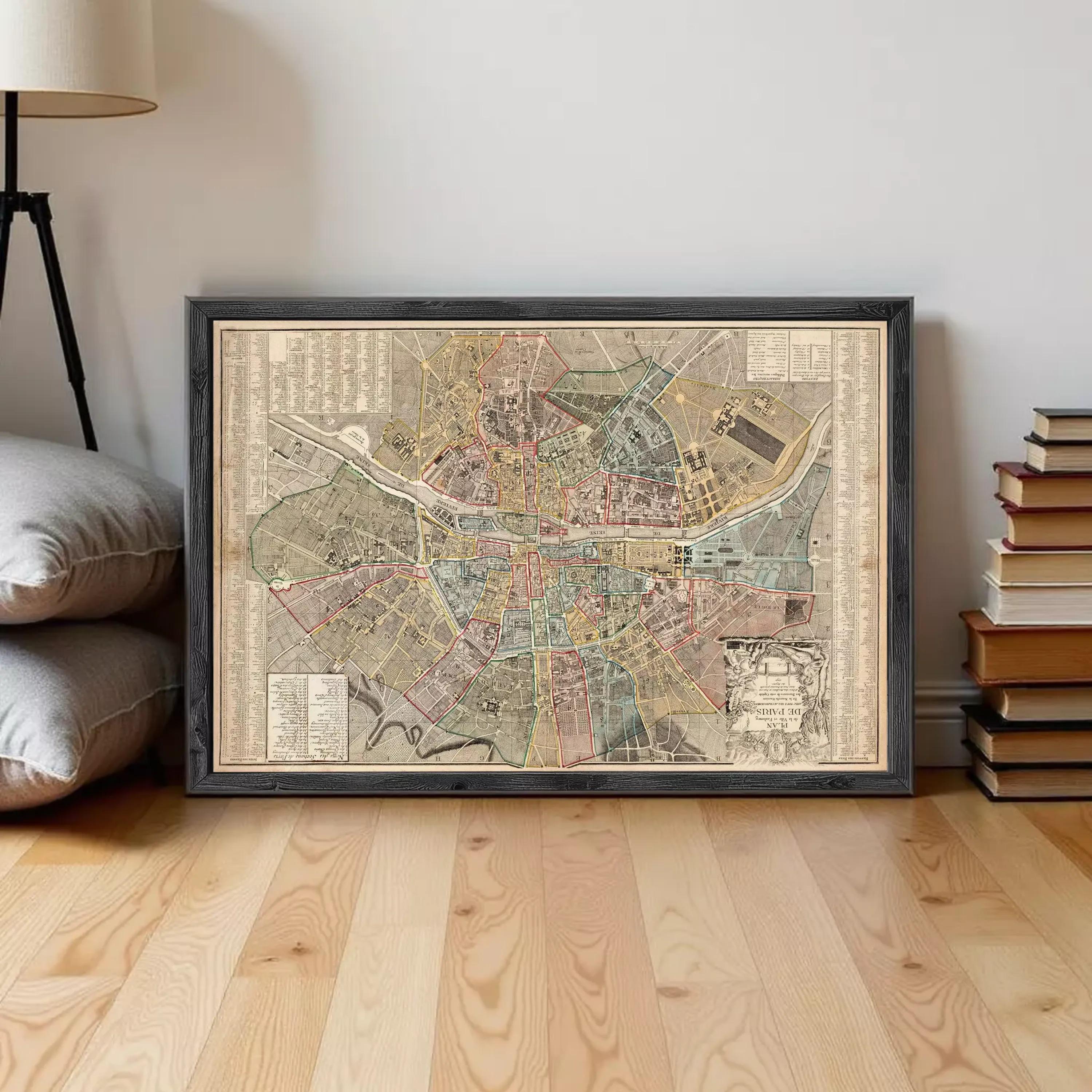The image is a framed vintage map of a city, likely from the 19th century, displayed on a white wall.
