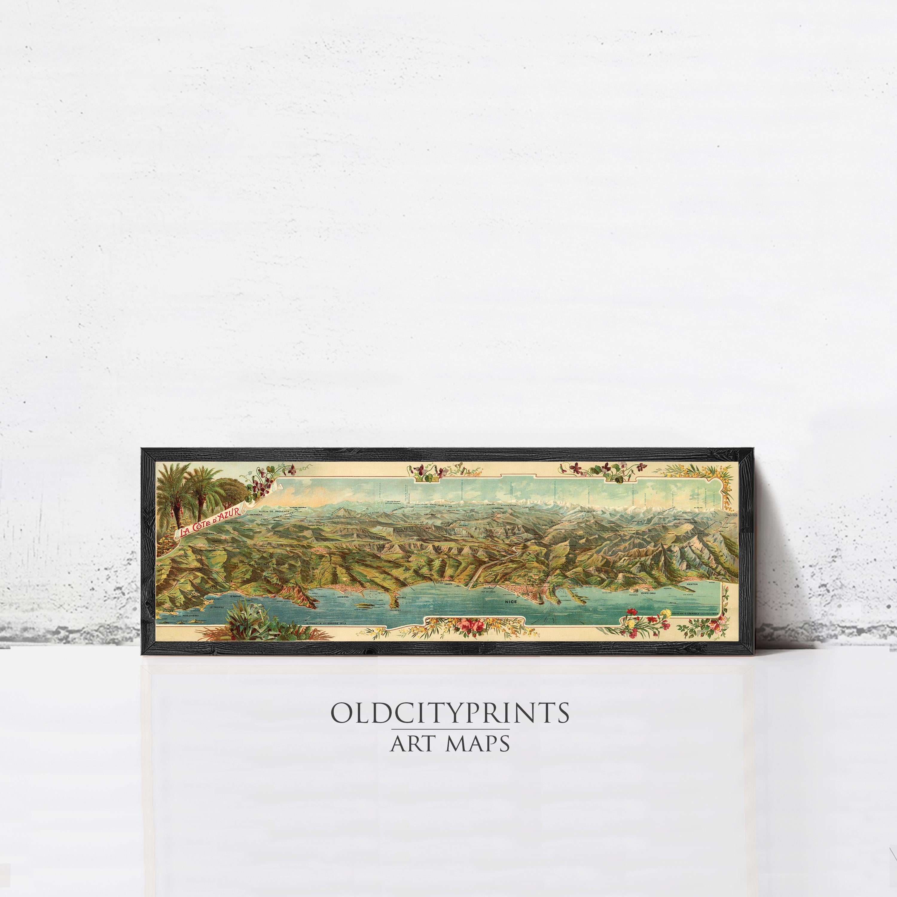 A framed vintage map of a coastal city, depicting a lush landscape with palm trees and a body of water.