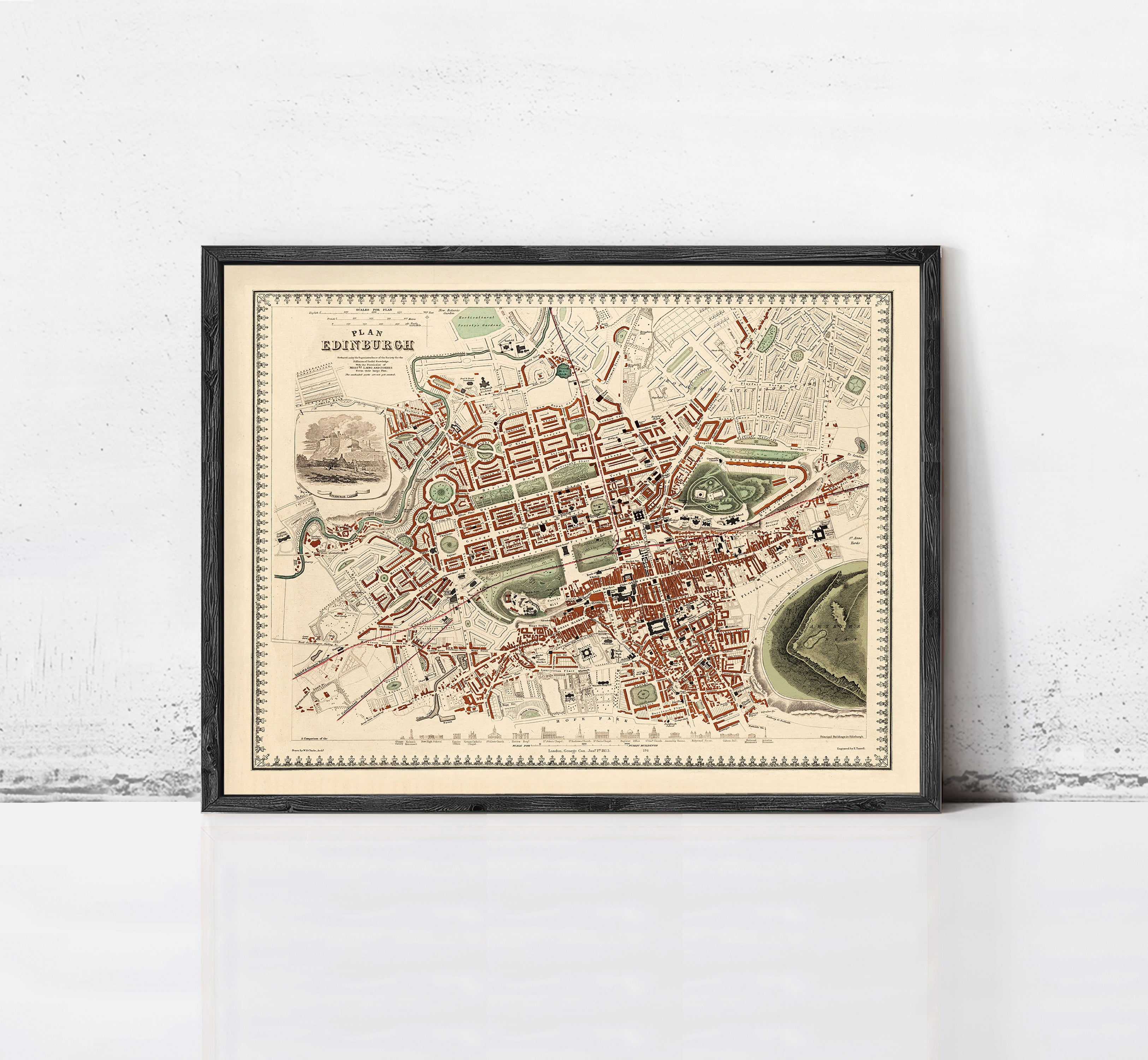 The image is a framed vintage map of a city, depicting a detailed layout of streets, buildings, and other urban features.