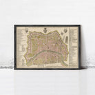 The image is a framed map of a city, likely Paris, with detailed labels and a color scheme of green, yellow, and brown.