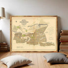a large framed map of Johannesburg, South Africa, with a wooden floor and a stack of books in the background.