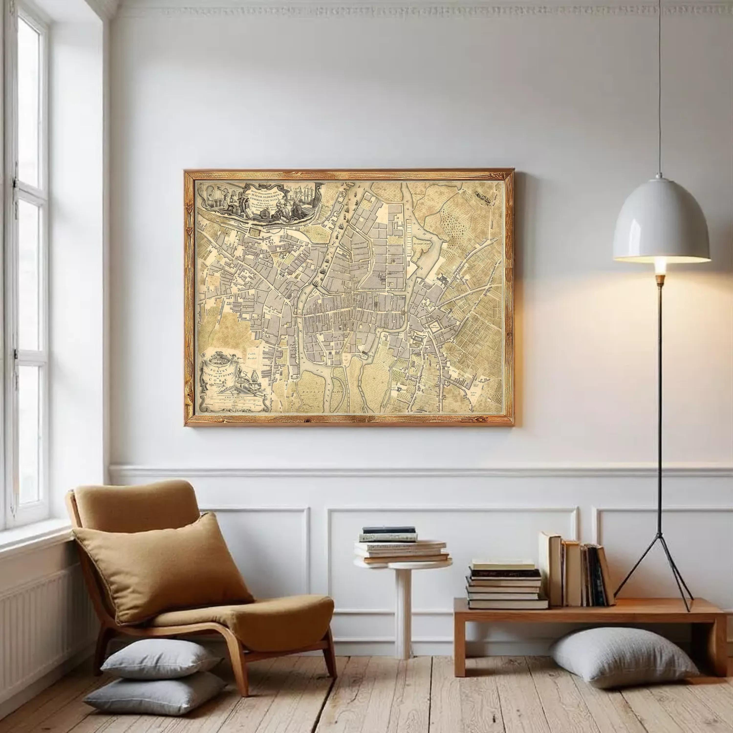 The image is a framed antique map of a city, likely from the 17th century, displayed on a white wall.