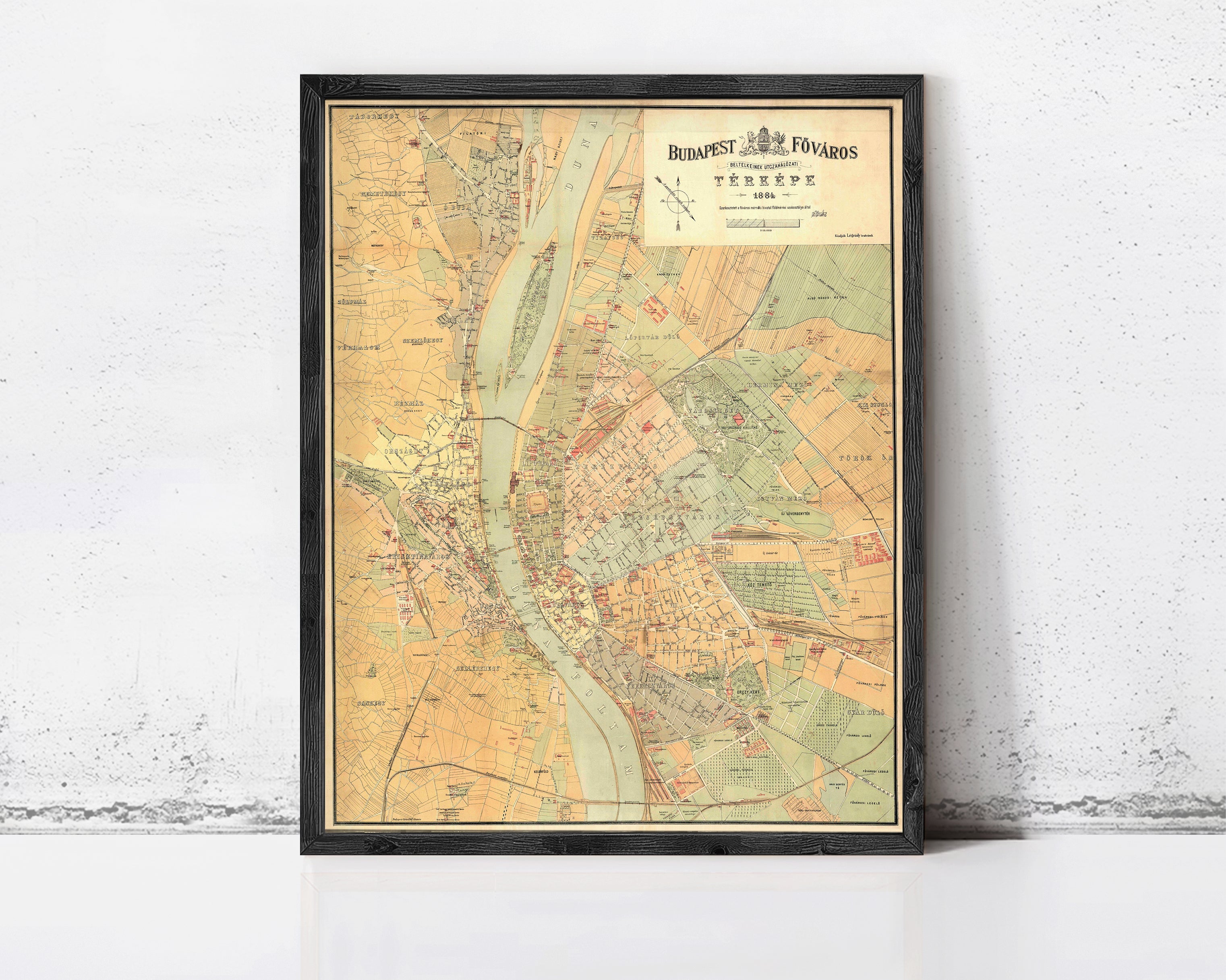 The image is a framed vintage map of Budapest, Hungary, depicting the city's streets and surrounding areas.