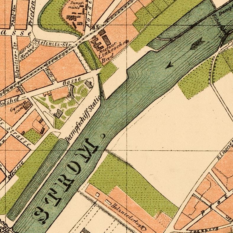 The image is a detailed map of a city, showing streets, buildings, and a river.