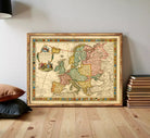 The image is a framed antique map of Europe, featuring detailed cartography and colorful borders.