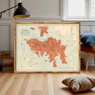 The image is a framed vintage map of Hong Kong, depicting the island and surrounding areas in a detailed and colorful manner.