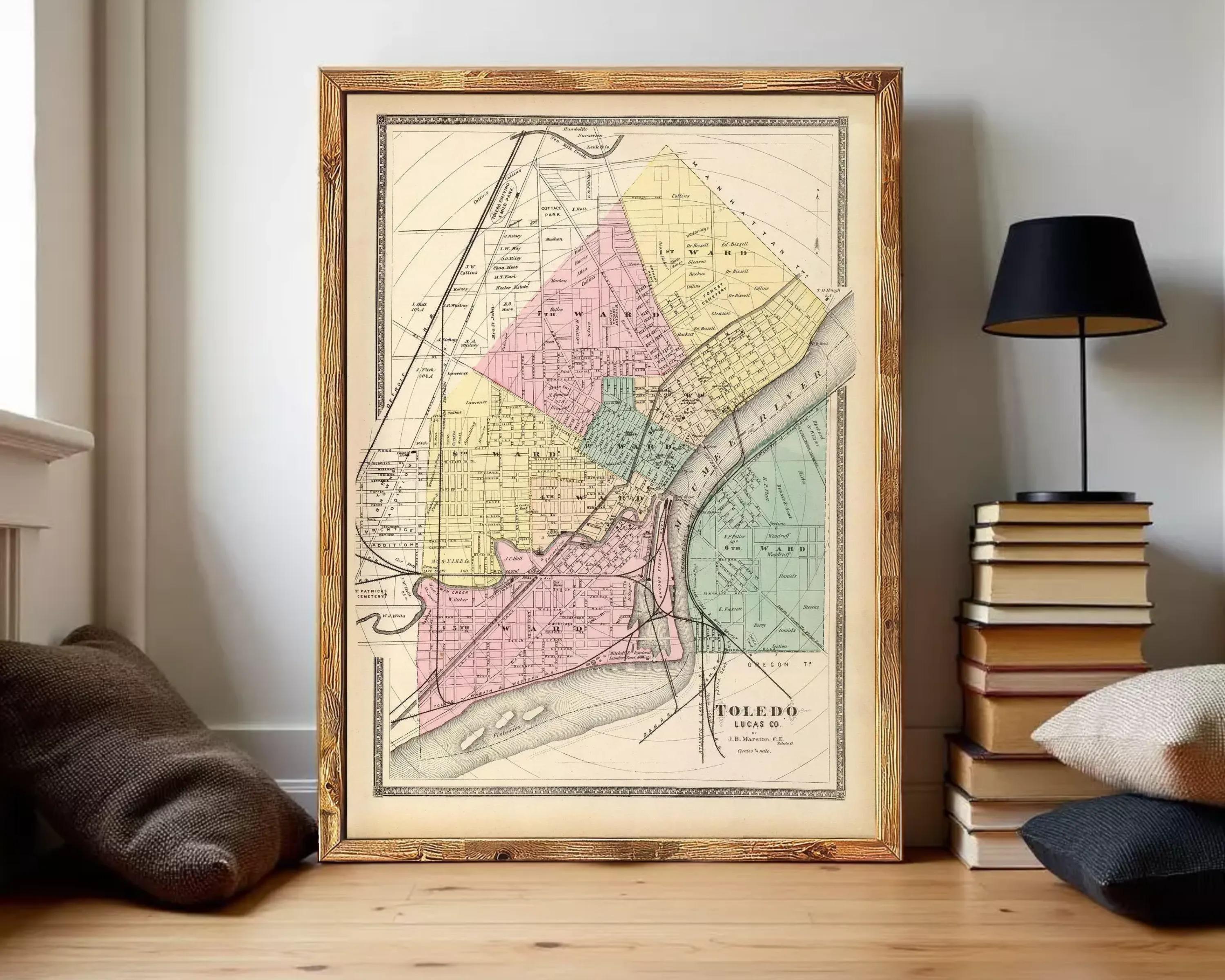 The image is a framed vintage map of the city of Toledo, Ohio, depicting the city's streets and neighborhoods in a detailed and colorful manner.