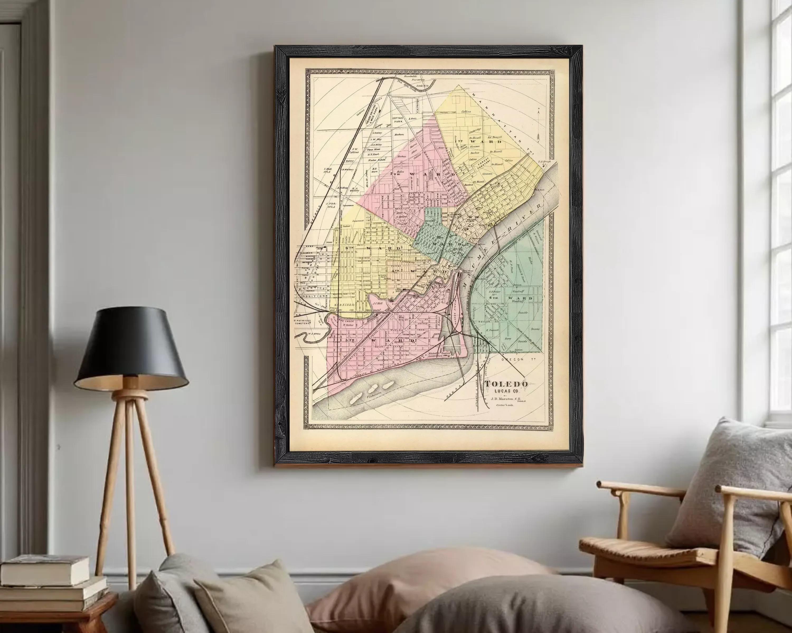 The image is a framed vintage map of the city of Toledo, Ohio, depicting the city's streets and neighborhoods in a detailed and colorful manner.