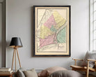 The image is a framed vintage map of the city of Toledo, Ohio, depicting the city's streets and neighborhoods in a detailed and colorful manner.