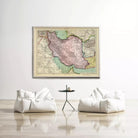 a large framed map of Iran hanging on a white wall, with two white bean bag chairs positioned in front of it.