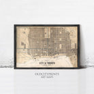 The image is a framed vintage map of Toronto, Canada, depicting the city's streets and landmarks.