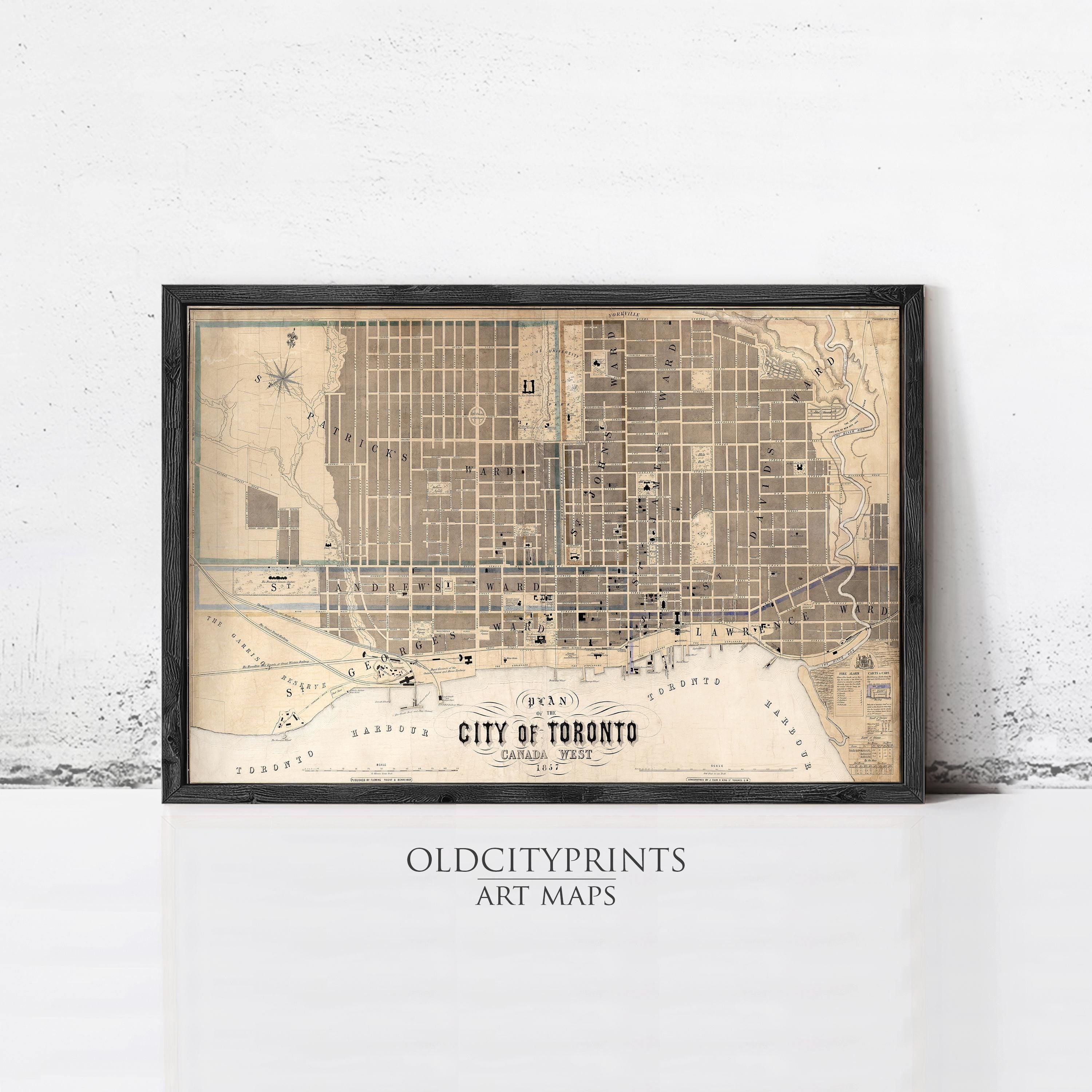 The image is a framed vintage map of Toronto, Canada, depicting the city's streets and landmarks.