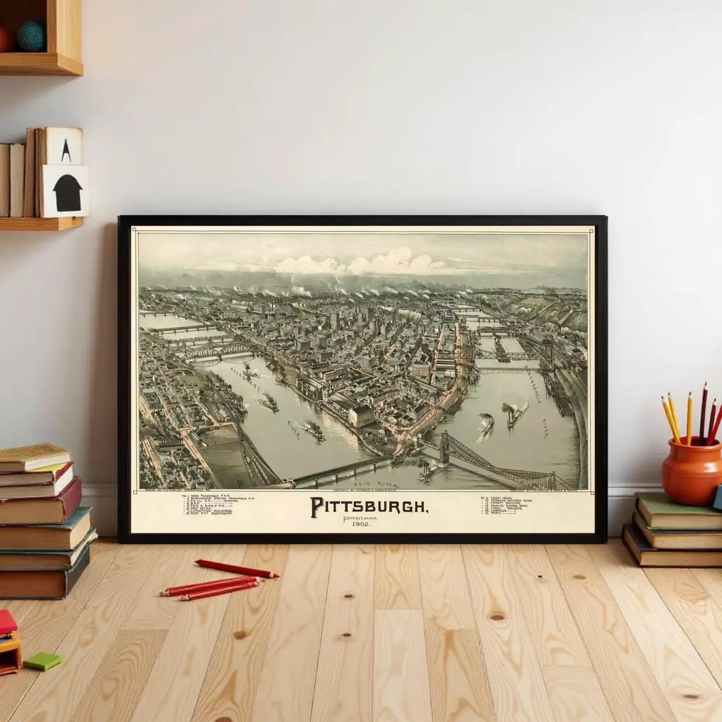 A framed vintage map of Pittsburgh, Pennsylvania, depicting the city's layout and surrounding areas.