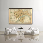 a large framed map of a city hanging on a wall, with two white bean bag chairs positioned in front of it.