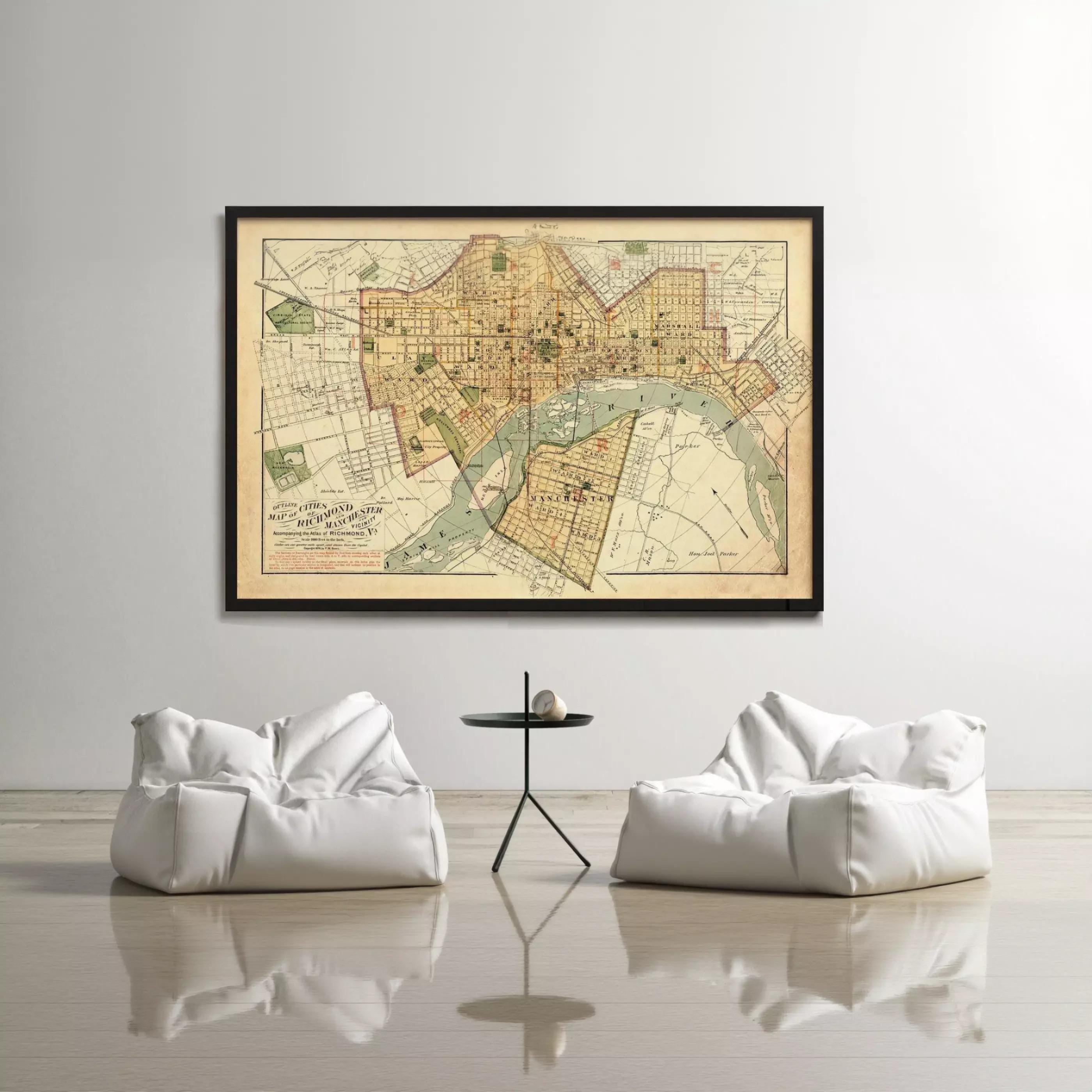 a large framed map of a city hanging on a wall, with two white bean bag chairs positioned in front of it.