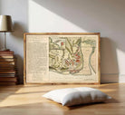 The image is a framed historical map of a city, likely from the 17th century, with detailed illustrations and labels.