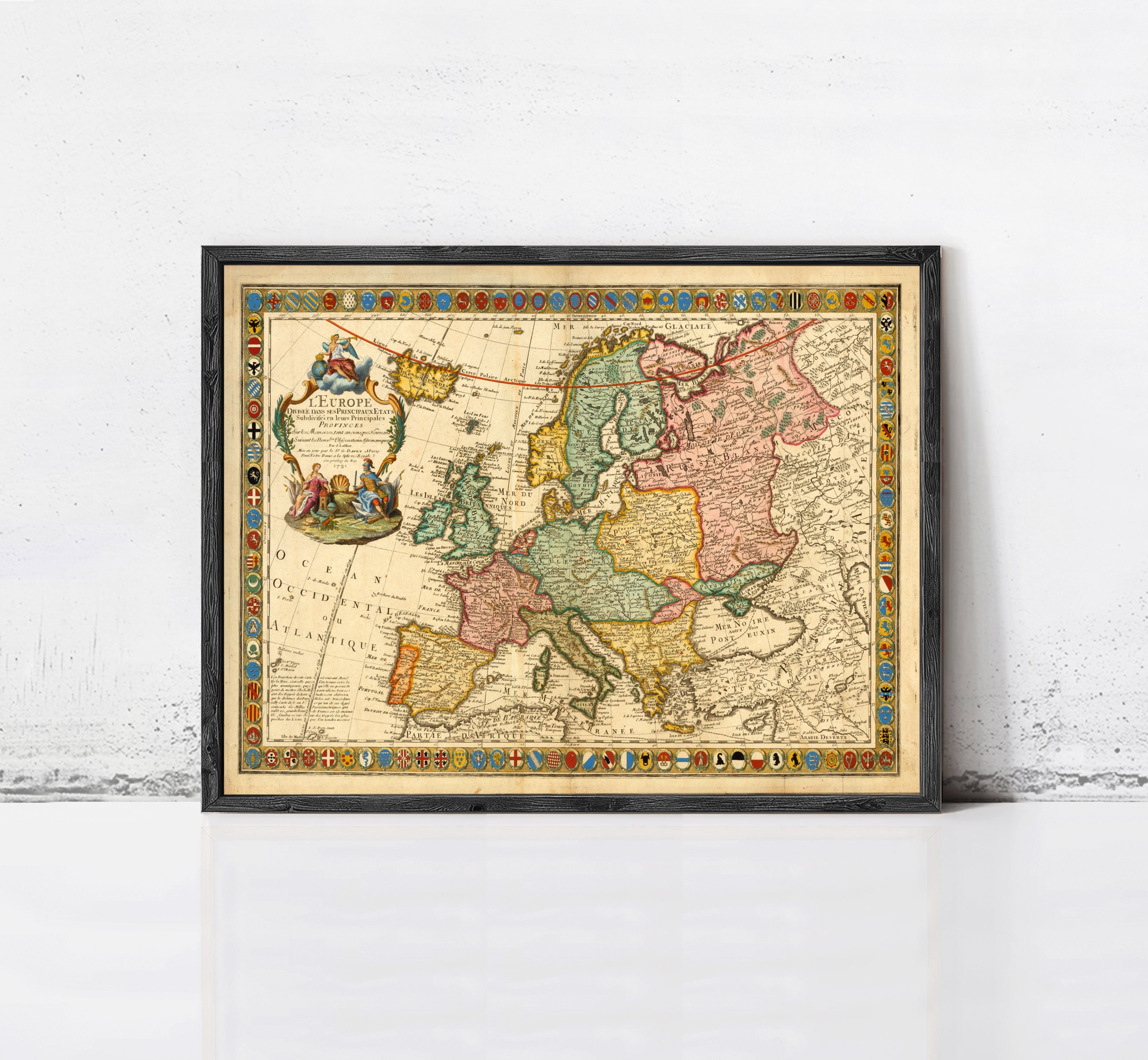 The image is a framed antique map of Europe, featuring detailed cartography and colorful borders.
