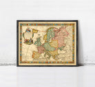 The image is a framed antique map of Europe, featuring detailed cartography and colorful borders.