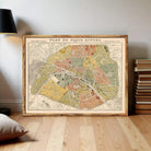 The image is a framed vintage map of Paris, France, depicting the city's streets and landmarks.