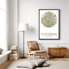 a living room with a large map of St. Petersburg hanging on the wall, a wooden side table, a beige armchair, and a stack of books.