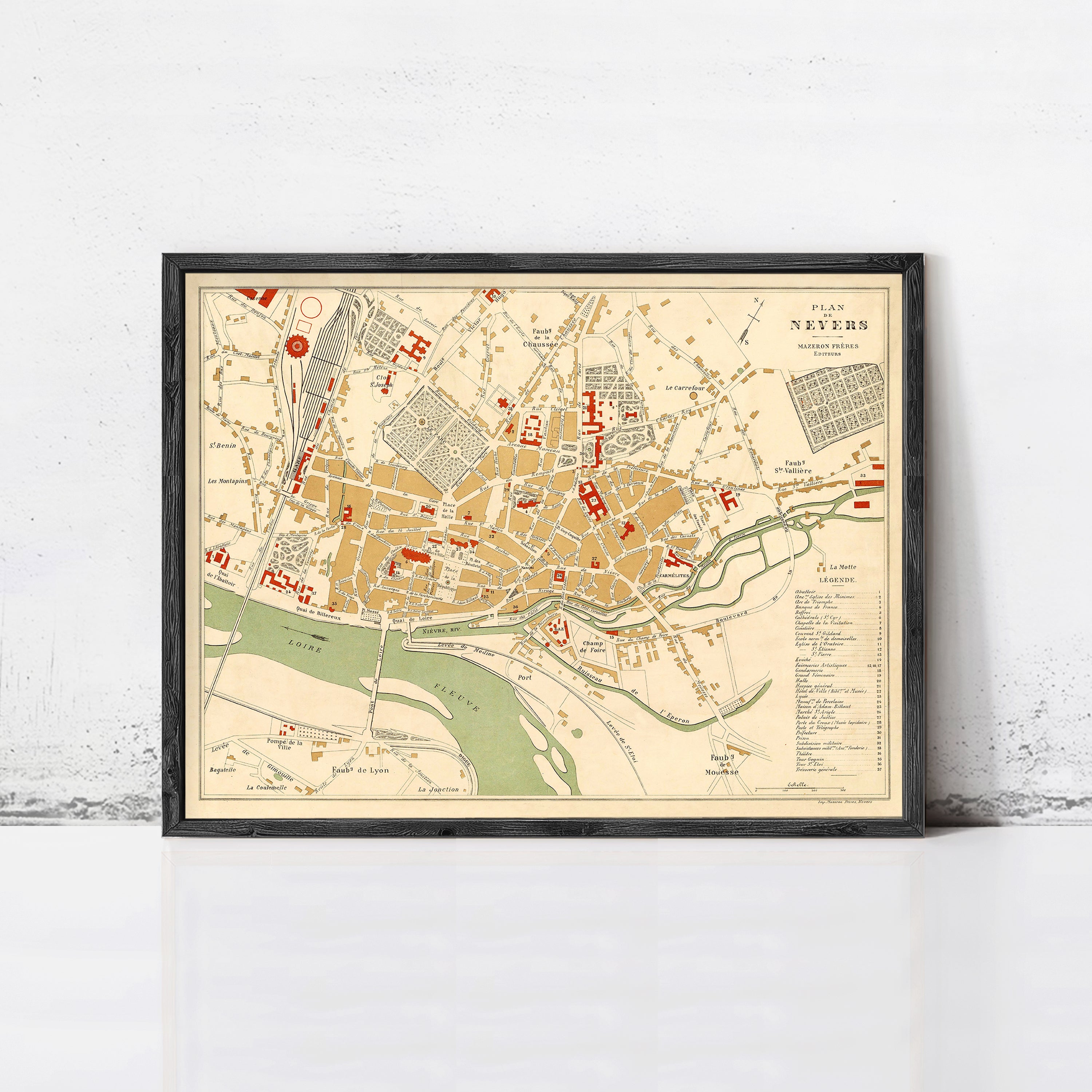 The image is a framed vintage map of a city, likely from the 19th century, depicting the layout and streets of the area.