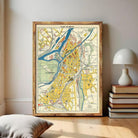 The image is a framed vintage map of a city, likely from the 19th century, with various streets, landmarks, and geographical features depicted.