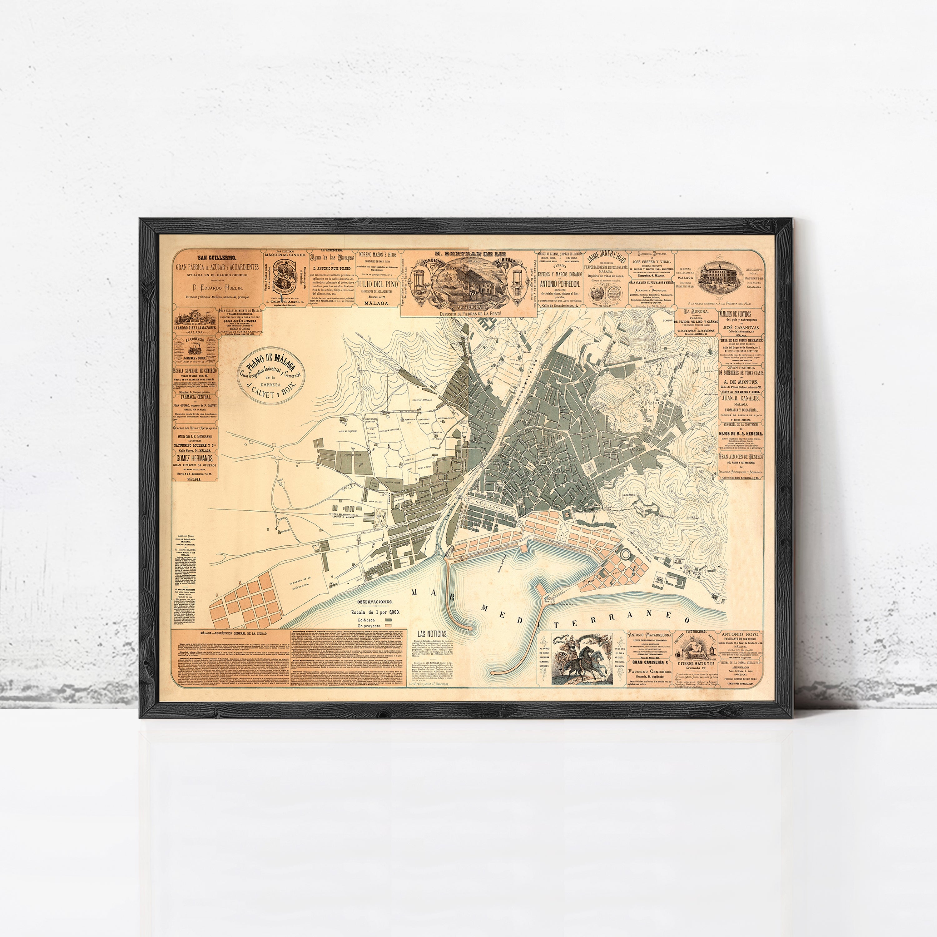 The image is a framed vintage map of a city, likely from the 19th century, with detailed street and geographical information.