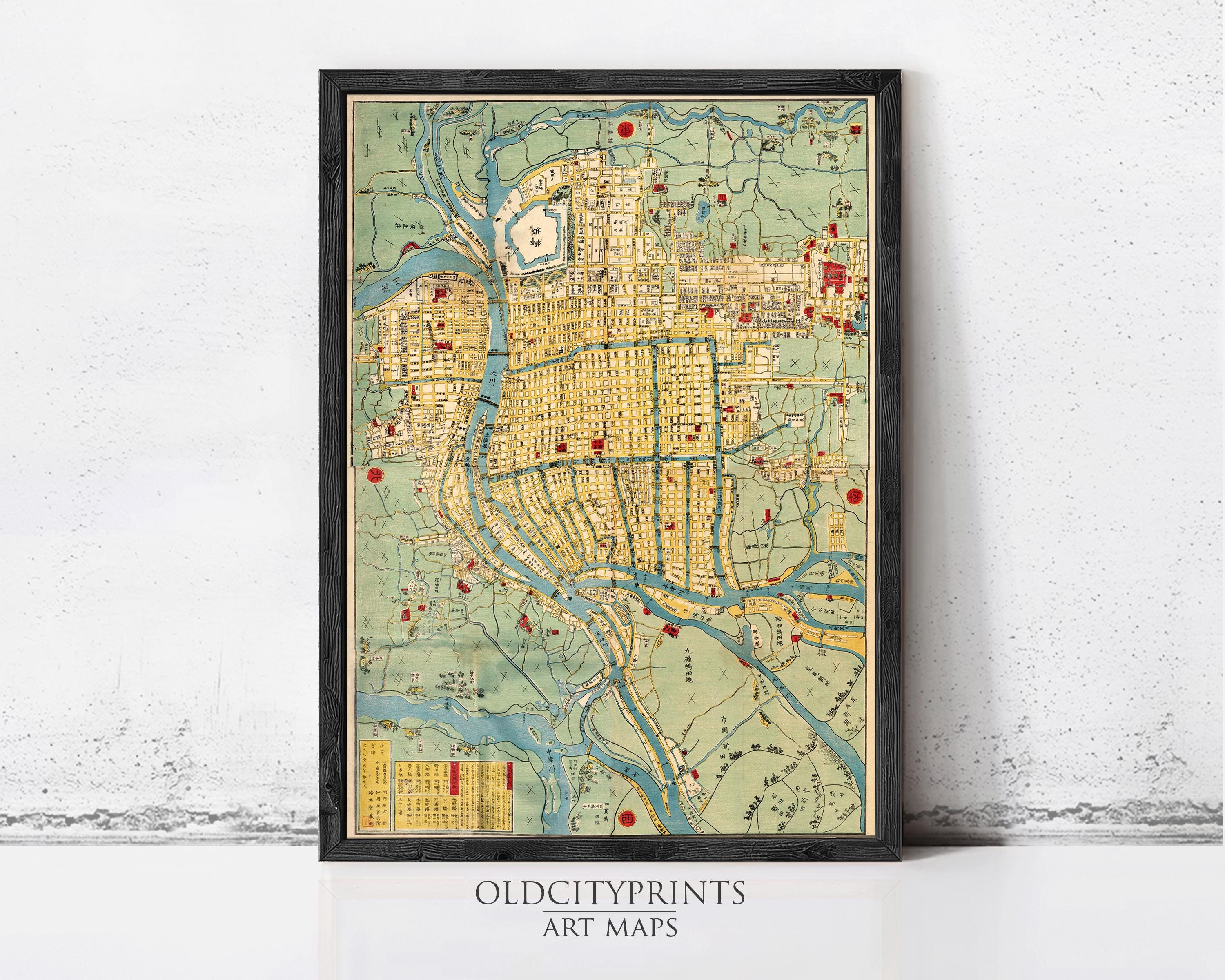 The image is a framed vintage map of an Asian city, likely from the 19th century, with various landmarks and streets depicted in a detailed and colorful manner.