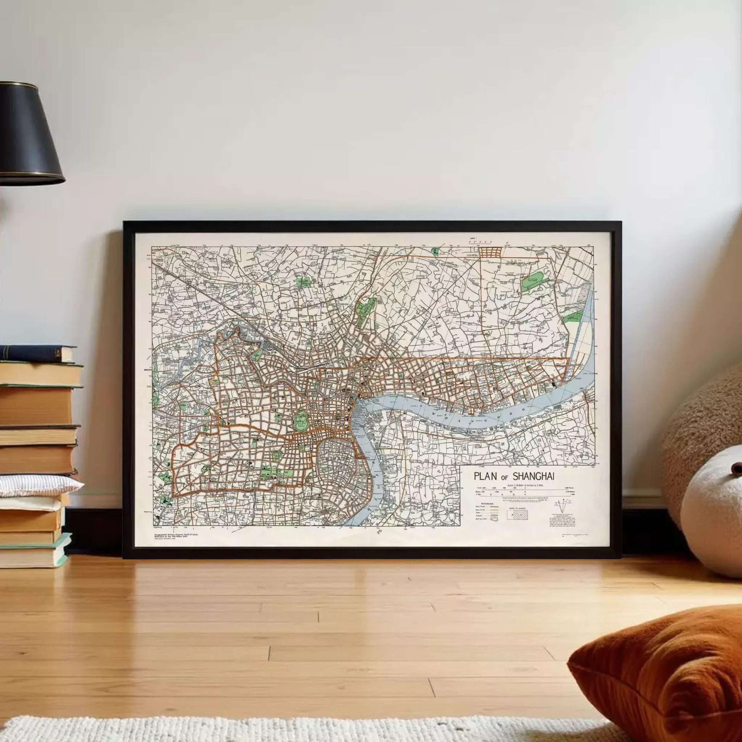 A framed map of Shanghai, China, with a river and various streets visible.