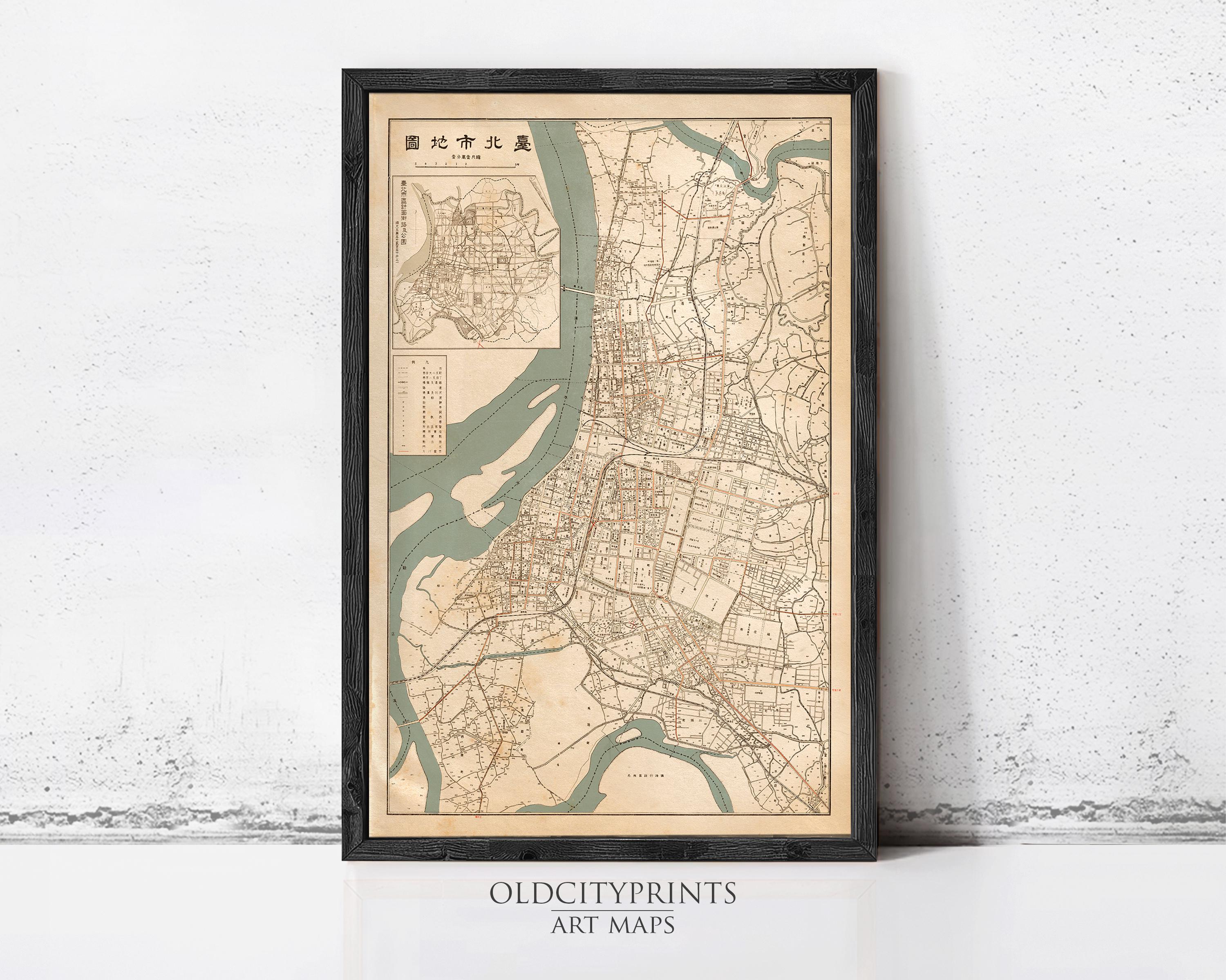 The image is a framed antique map of a city, likely from the 19th century, displayed on a wall.