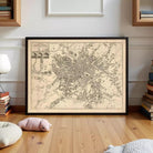 The image is a framed map of a city, likely a historical or geographical map, displayed on a white wall.